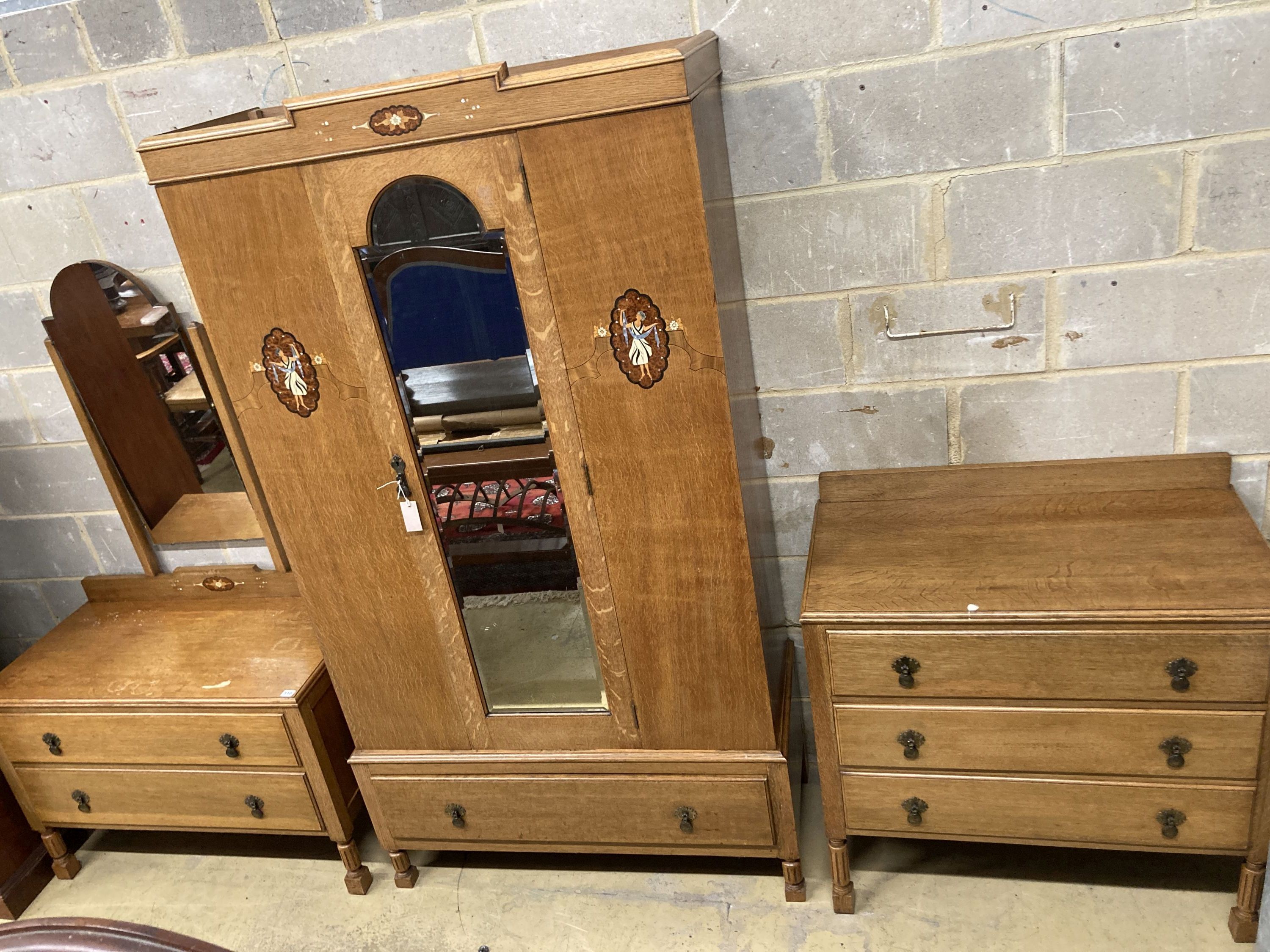 An early 20th century inlaid oak three piece bedroom suite, wardrobe width 106cm, depth 43cm, height 193cm